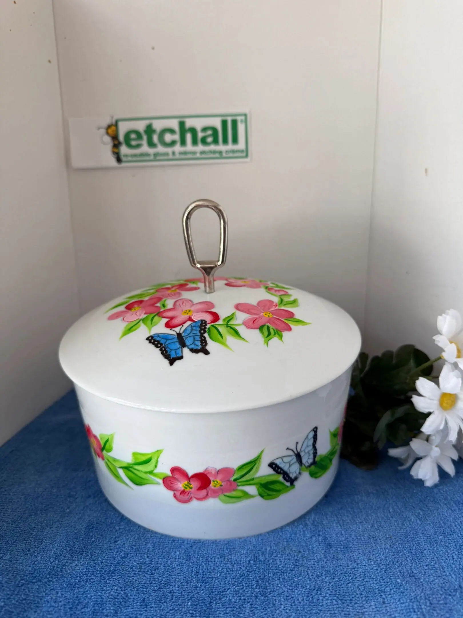 White container with pink flowers and butterflies