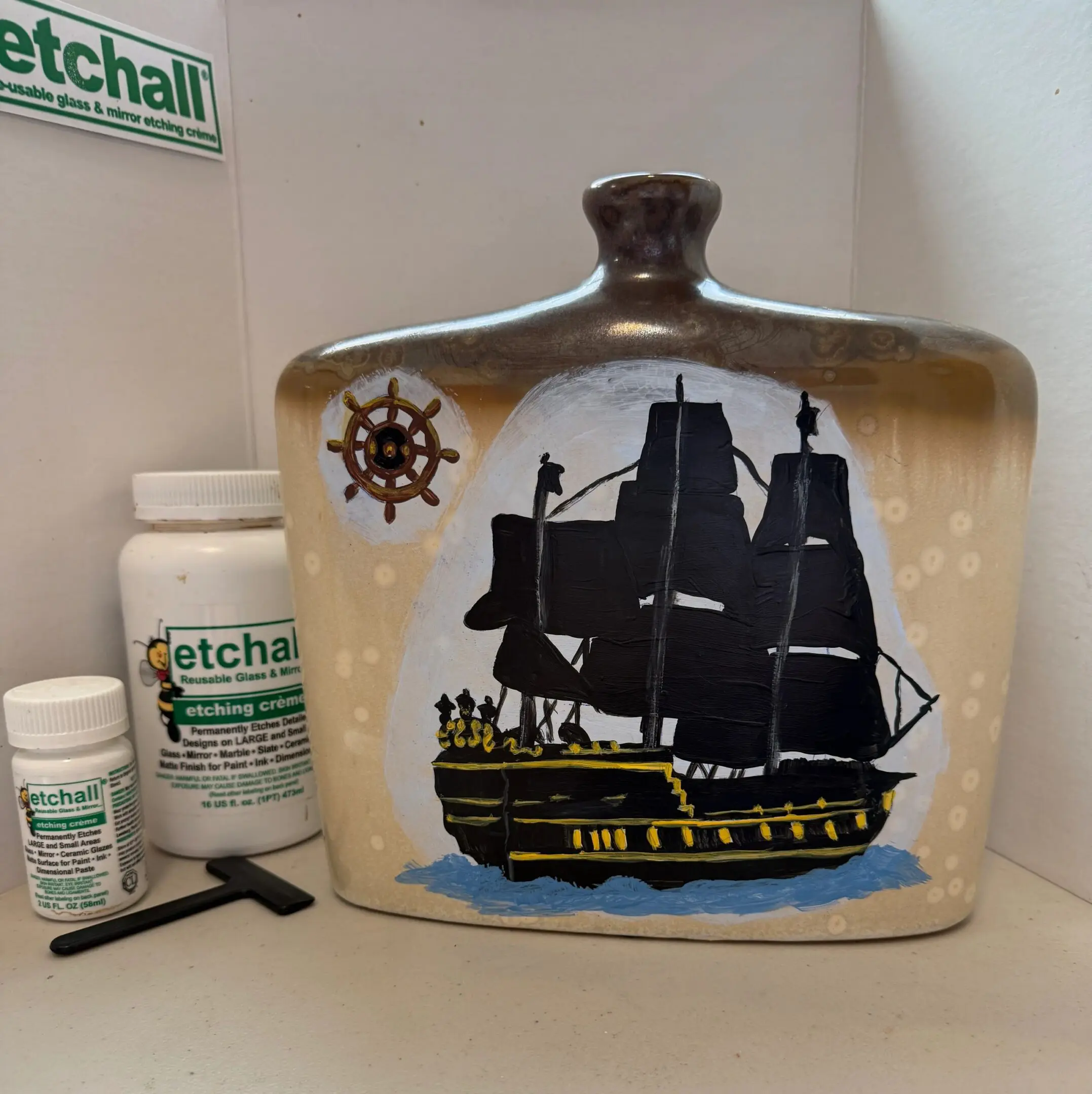 Nautical-themed artwork on decorative bottle