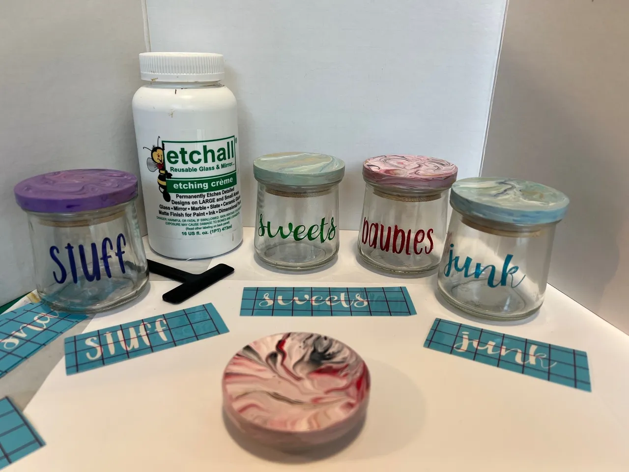 Jars with labels and etching cream bottle.
