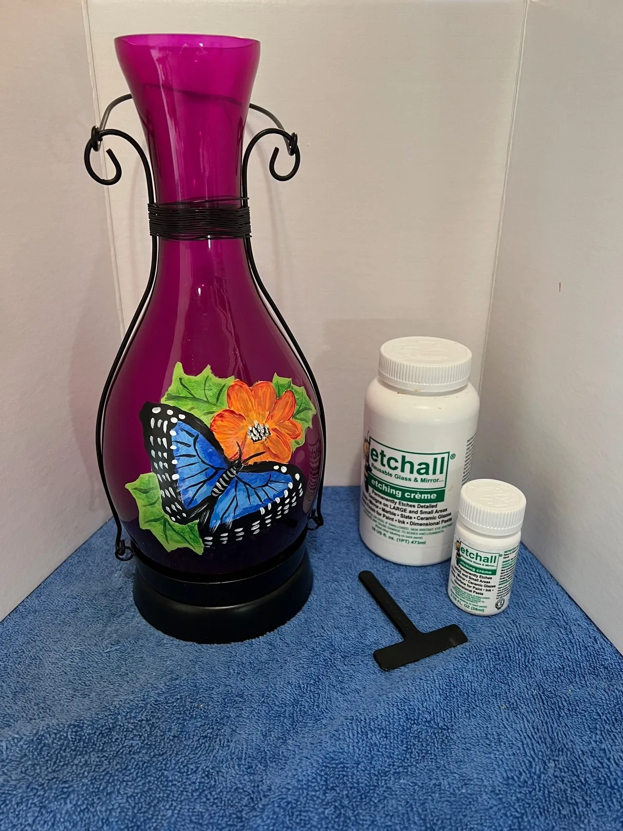 Purple vase with butterfly, etching cream bottles.