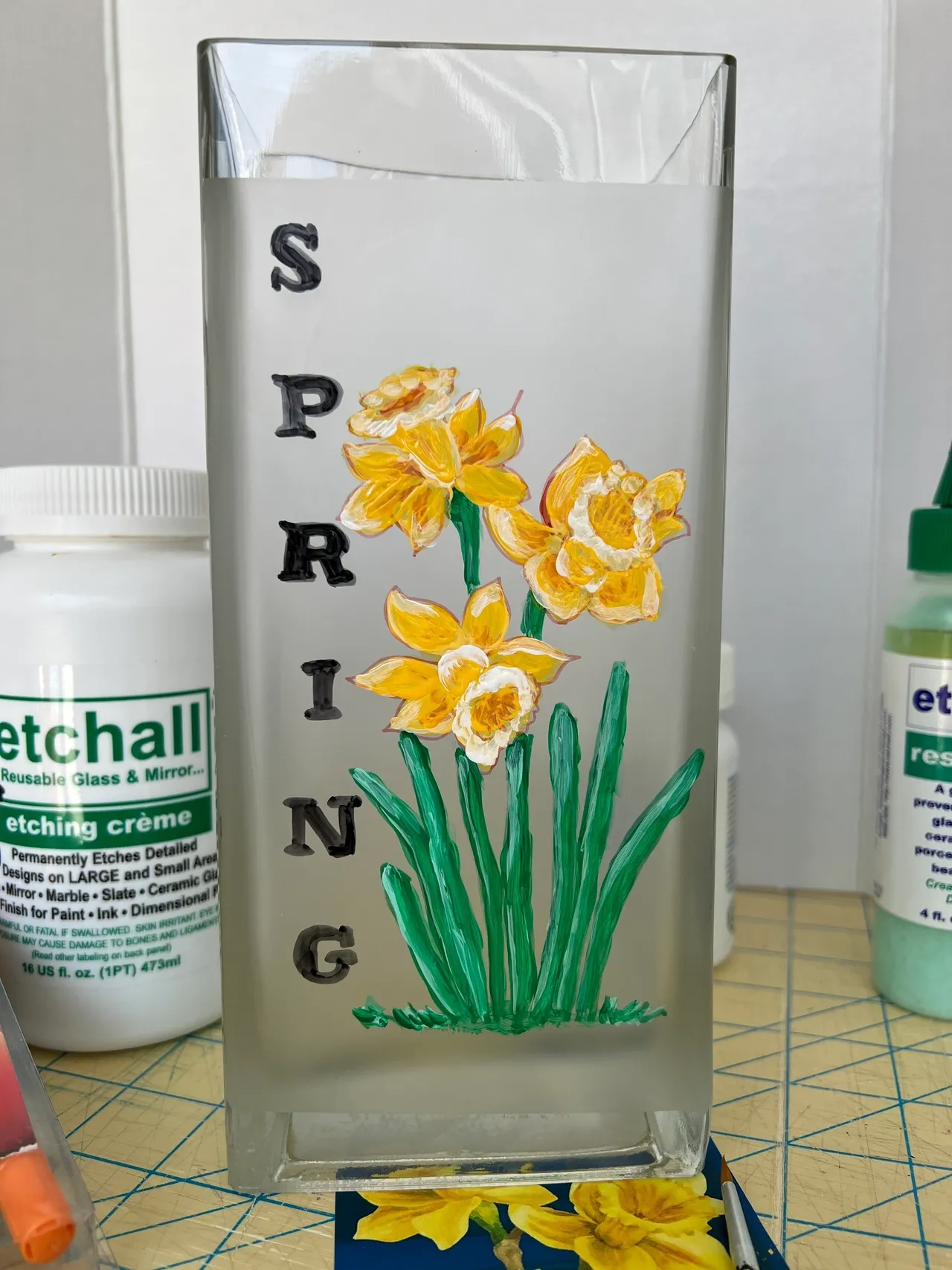 Vase with painted daffodils and "Spring".